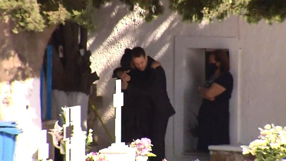 During his late wife's memorial service on Thursday, Babis Anagnostopoulos was pictured hugging his late wife's mother