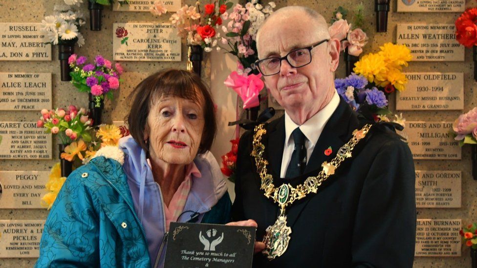 Gina Jacobs and Mayor Jerry Williams with a plaque thanking cemetery staff for their support and assistance