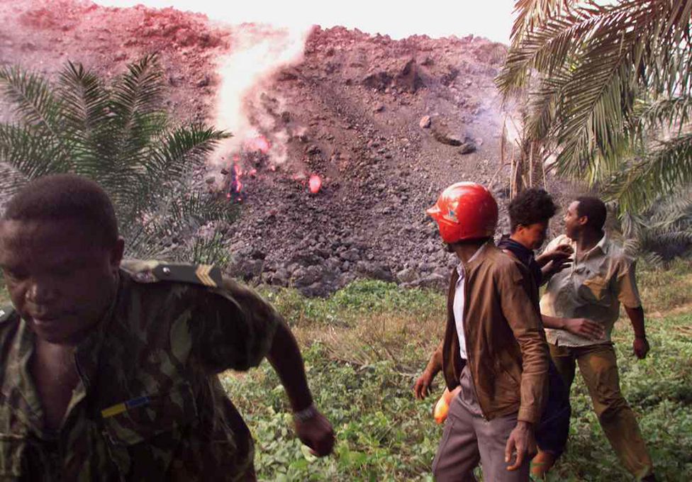 People flee a river of molten lava during Mount Cameroon's 1999 eruption