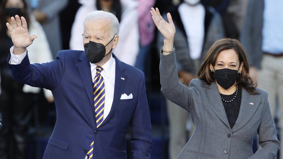 Joe Biden and Kamala Harris wave