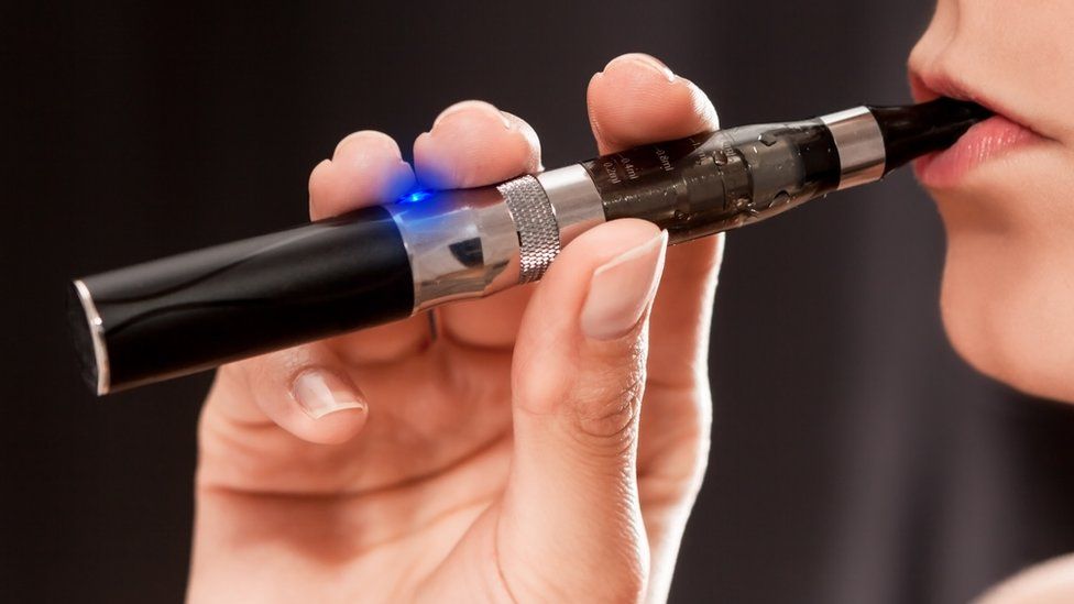 Close up of woman holding e-cigarette