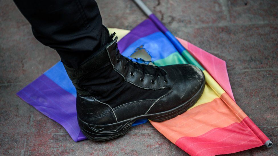 A riot police officer steps on a gay rights flag in Istanbul, 19 June