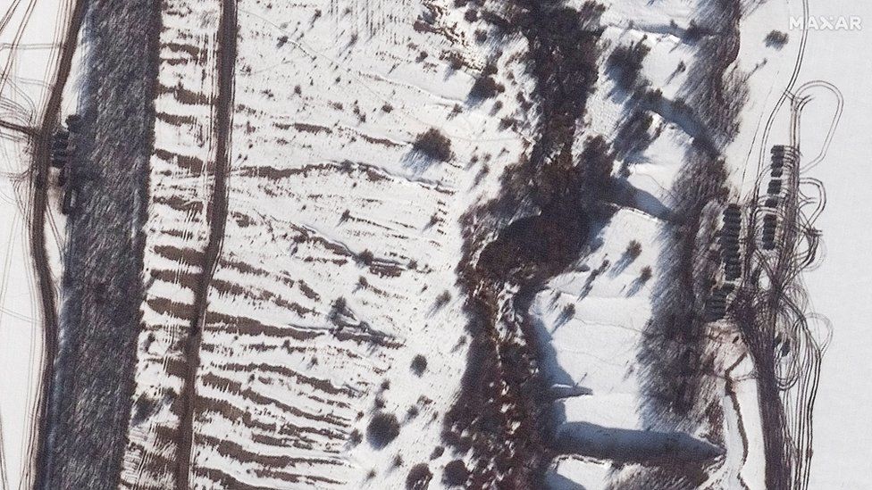 A satellite image shows additional armour and equipment deployed along a tree line, near Valuyki, Russia