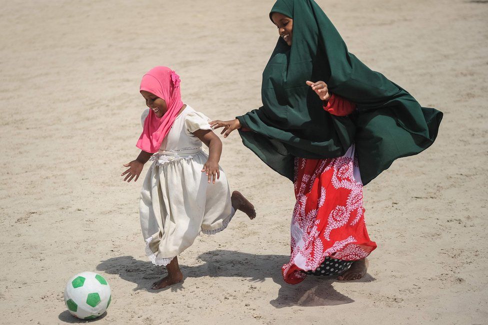 Somali girls play football on the Lido beach in Mogadishu, on January 12, 2018.