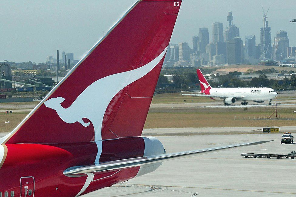 Qantas jets on the tarmac overlooking the city of Sydney