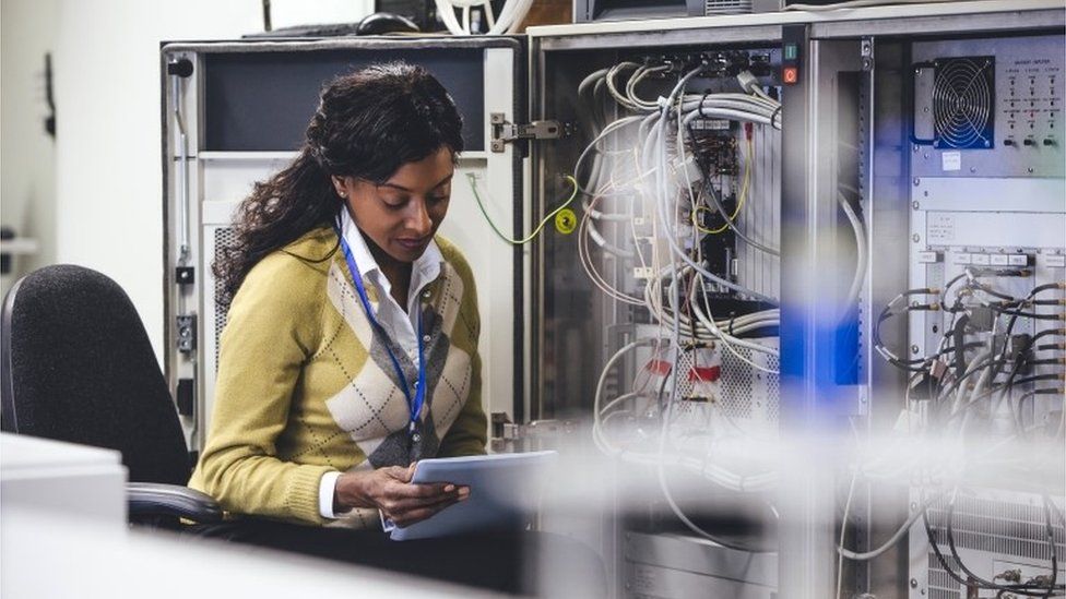 Creative pic of woman checking network servers
