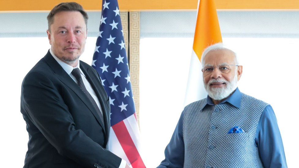 Elon Musk shaking hands with Narendra Modi
