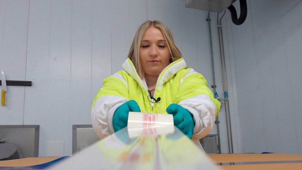 Natasha Varley, food inspector tapes boxes of chicken up