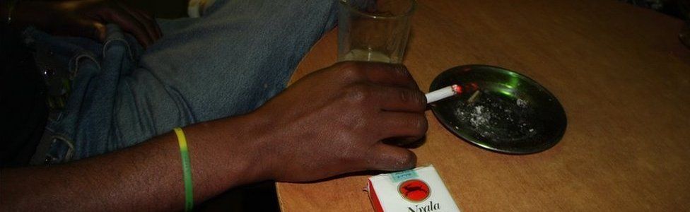 Inside a bar off Bole Road a man smokes Nyala, Ethiopia's locally made cigarette brand.