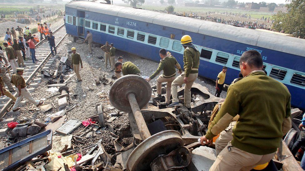 Rescue workers search for survivors at the site of a train derailment in Pukhrayan, south of Kanpur city, India November 20, 2016.