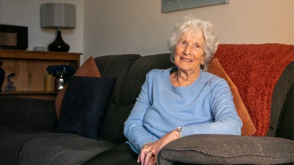 Sylvia Selway sitting on a sofa at home