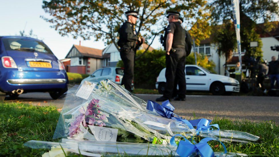 Flowers lie next to the scene where MP David Amess was stabbed