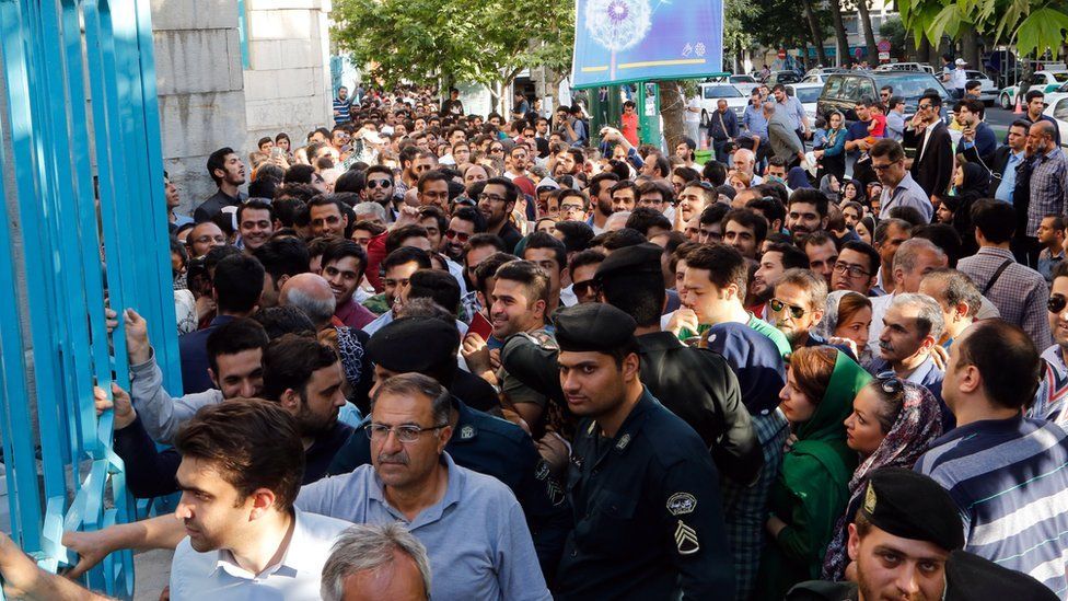 Iranians wait in a line to cast their ballots in the Iranian presidential elections outside a polling station in Tehran, Iran, 19 May 2017.