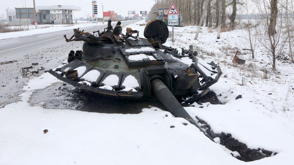 A blown-off tank turret lies on the ground on the outskirt of Kharkiv
