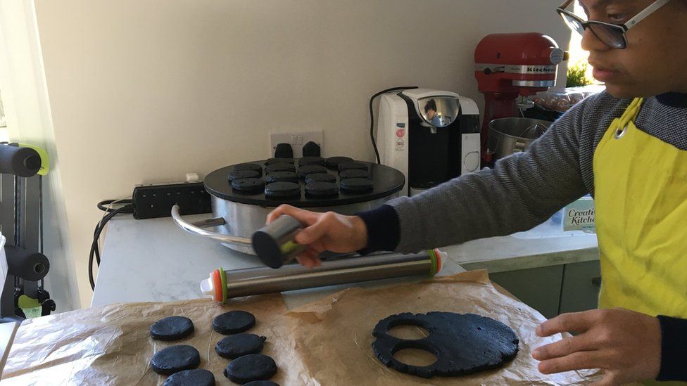 Michael cutting black welsh cakes