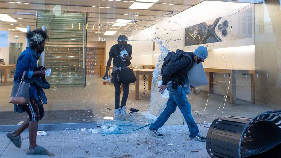 People are seen looting the Apple store at the Grove shopping centre in the Fairfax District of Los Angeles on May 30, 2020
