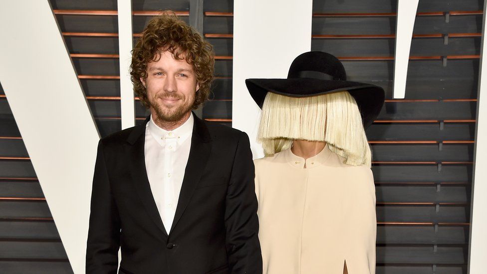 This is a photo of Sia and her husband Erik Anders Lang posing on a red carpet.