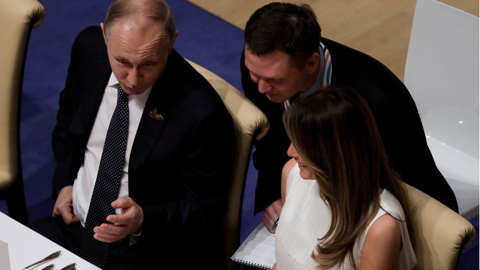 Russia's President Vladimir Putin talks to Melania Trump during the official dinner at the Elbphilharmonie Concert Hall during the G20 summit in Hamburg