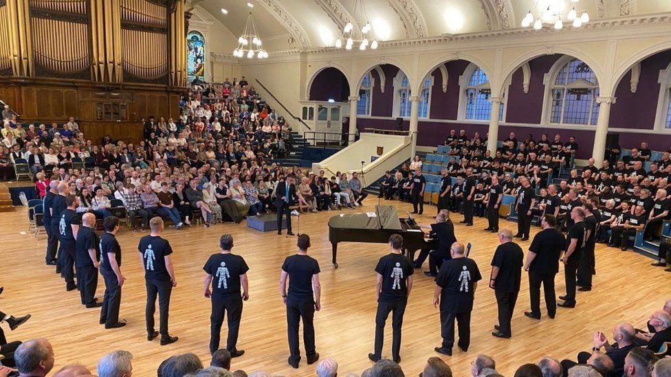 Peterborough Sings choir performing in Prostate Cancer UK shirts