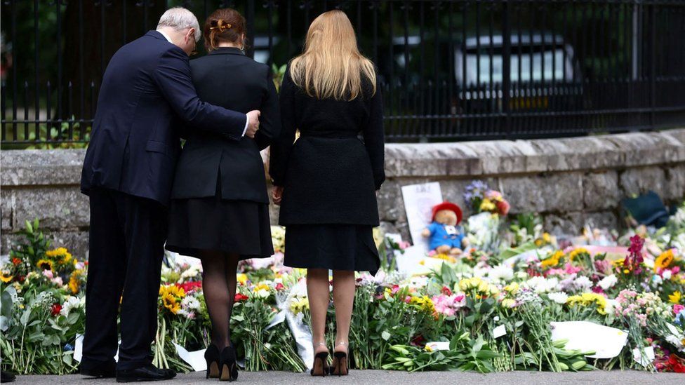 Prince Andrew and his daughters Princess Beatrice and Princess Eugenie view tributes outside Balmoral Castle