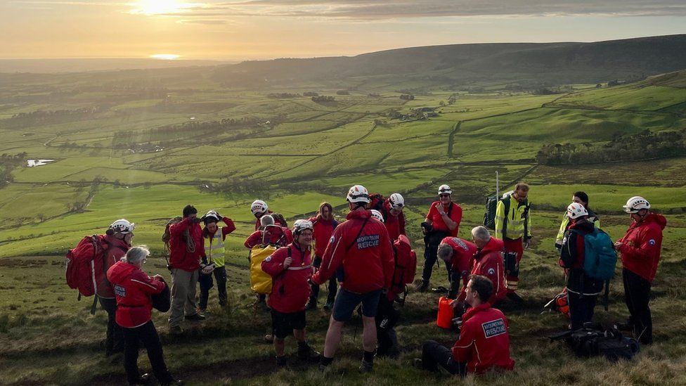 Mountain rescue team after man is airlifted off hill