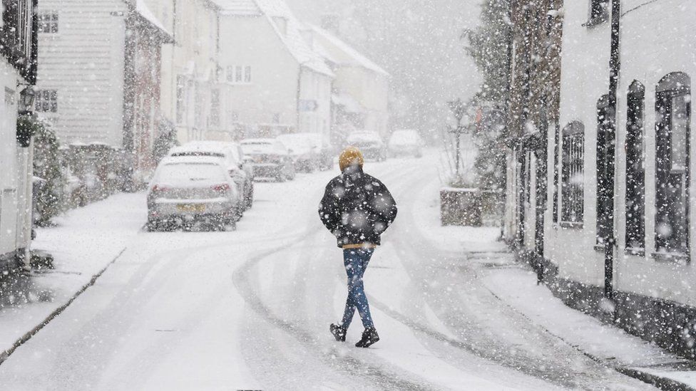 A person walking through a snow flurry in Lenham, Kent, on Monday