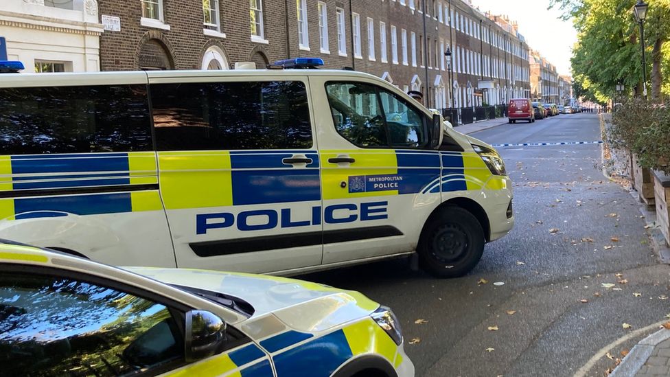 Police vehicles at scene of stabbing