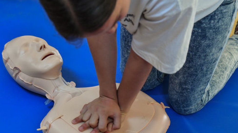 Child learning CPR