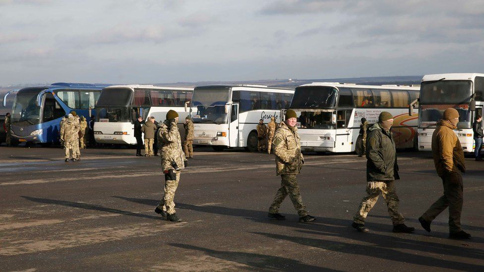 Servicemen of the Ukrainian armed forces gather near buses transporting prisoners near the city of Bakhmut in Donetsk region