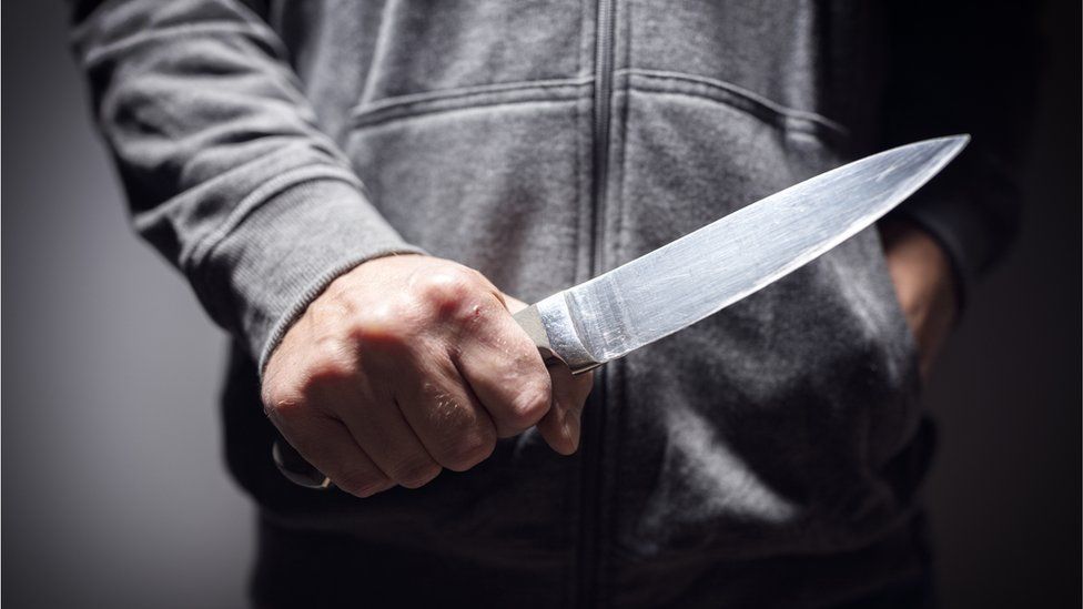 Stock image of man holding knife