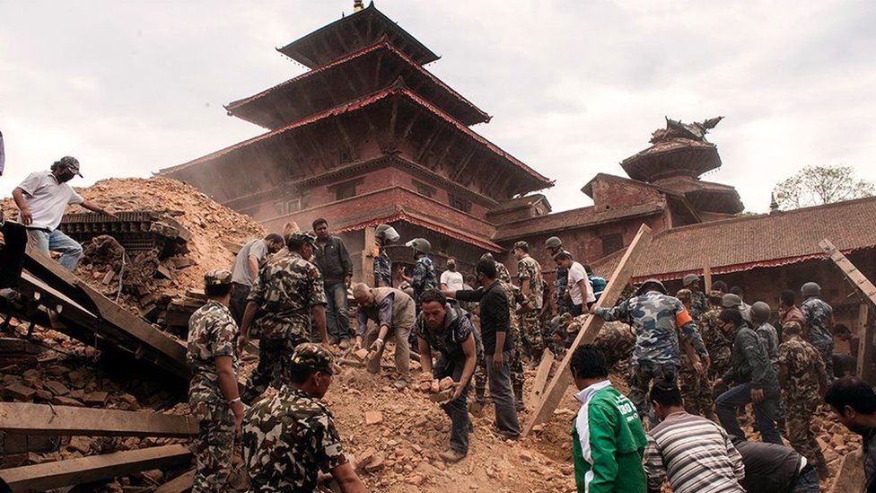 Rescuers search through rubble in the wake of April's earthquake
