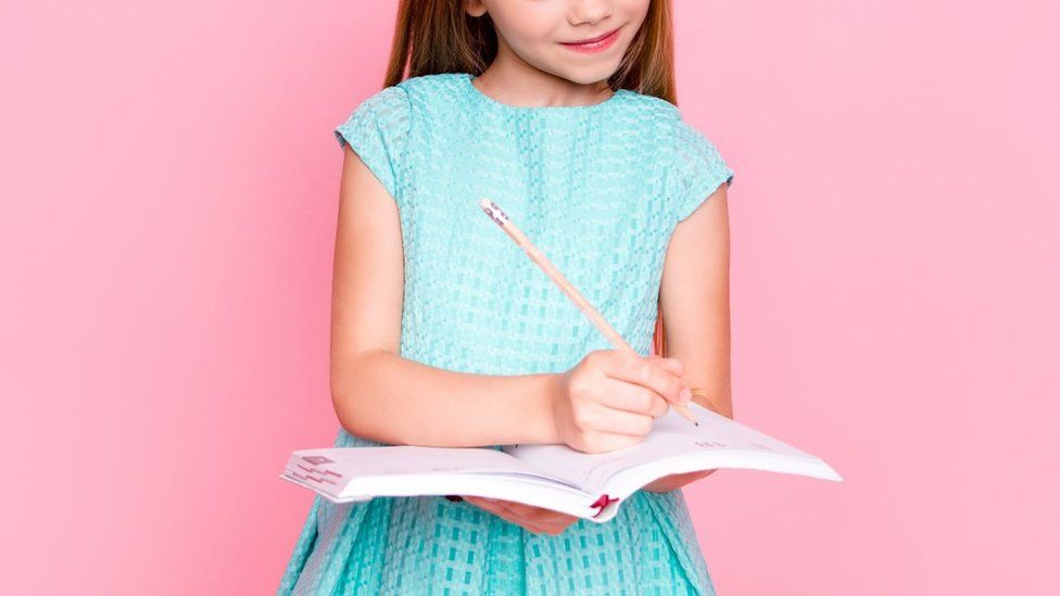 Stock image of a child writing