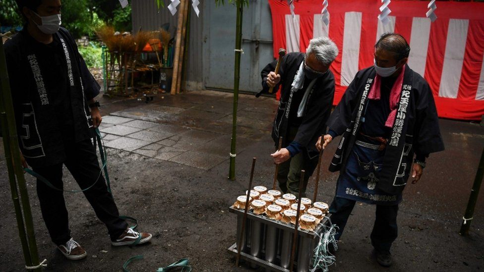 Pyrotechnicians prepare fireworks at the Okunitama shinto shrine in Fuchu in the western suburbs of Tokyo