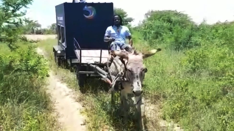 Community tablet being pulled by donkey