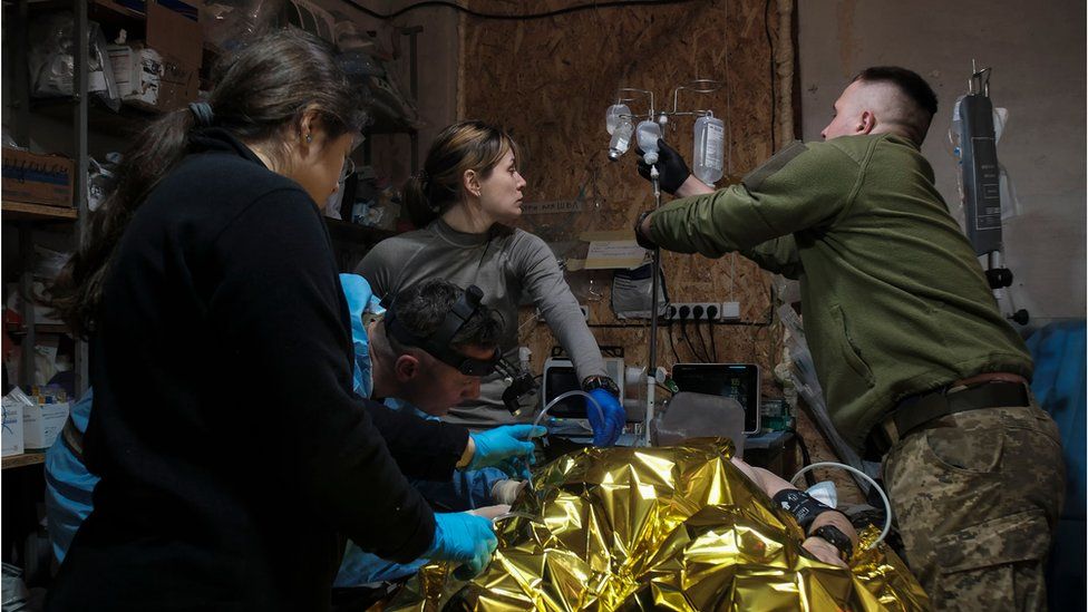 Medics treat a wounded Ukrainian soldier