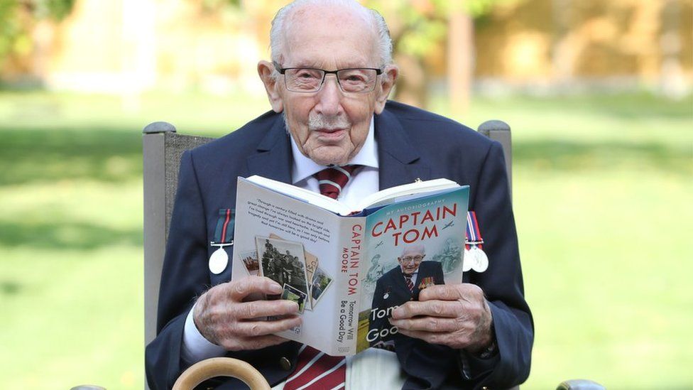 Capt Sir Tom Moore reads a copy of his autobiography Tomorrow Will Be A Good Day