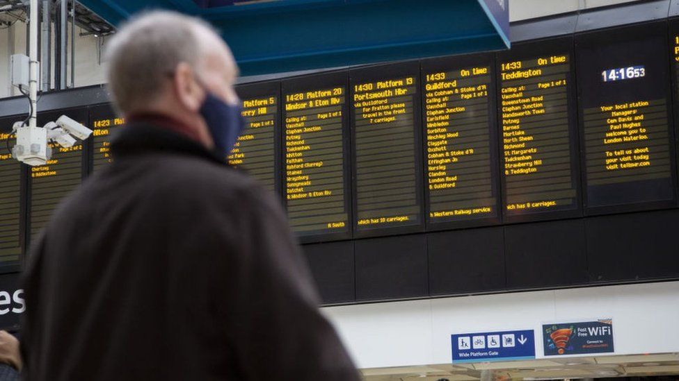 Man looking at departure board in London Euston