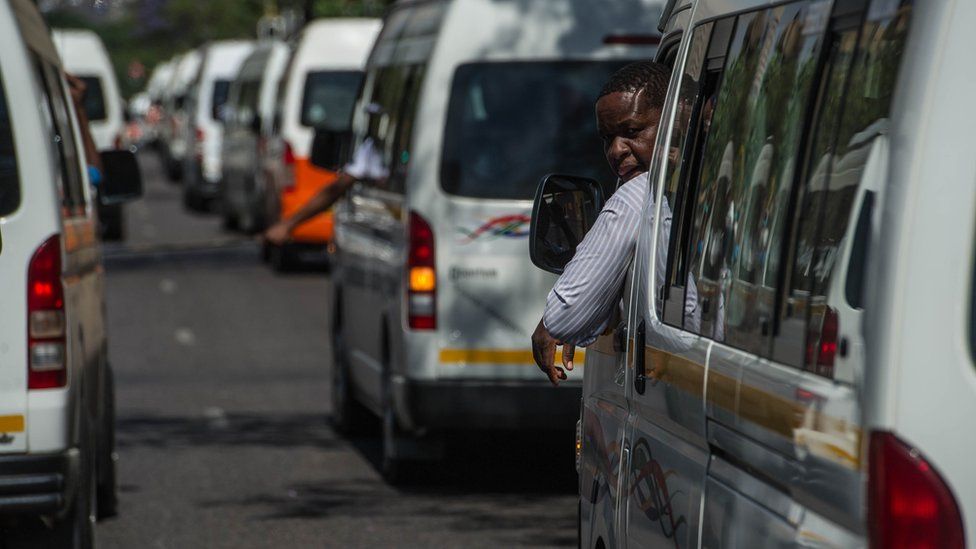 A taxi driver looks out his window while parked in a line of taxis in Pretoria.