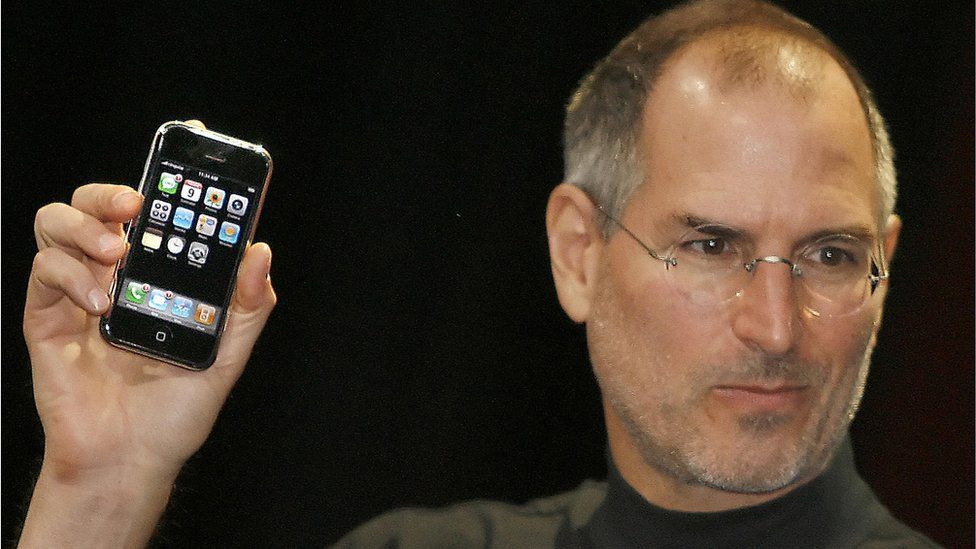 Steve Jobs holding first iPhone