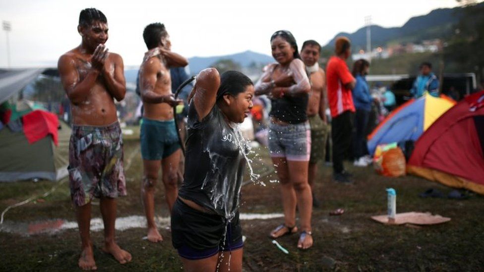 Colombian indigenous people take a bath as they prepare to participate in a protest in Fusagasuga, Colombia October 18, 2020.