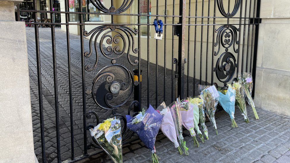 Bunches of flowers left at the gate of Carlyle's Court, Carlisle