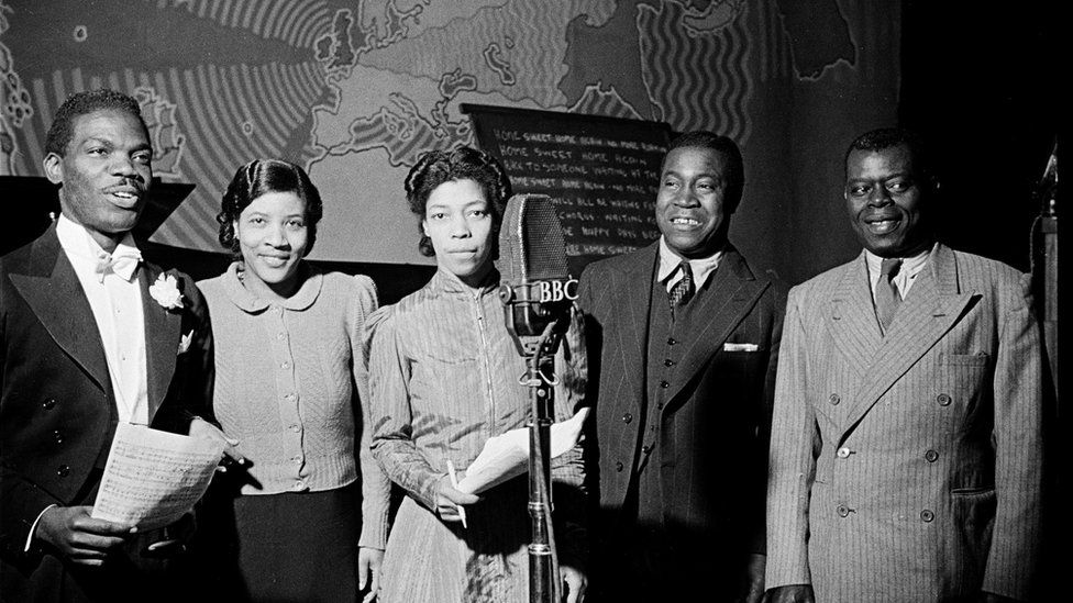 Una Marson (centre) introduces Uriel Porter, Gladys Taylor, the singer, Ike Hatch, the entertainer and Lionel Trim, the comedian, during a BBC broadcast to the West Indies in which these artists took part, and members of His Majesty's Forces from every island in the West Indies sent greetings to their parents and wives at home, 23rd December 1941.