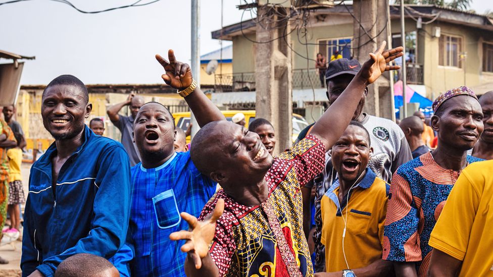 Celebrating people at a polling station in Agege, Lagos, Nigeria - Saturday 25 February 2023