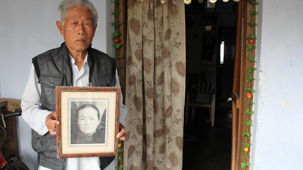 Mr Wang with a picture of his mother