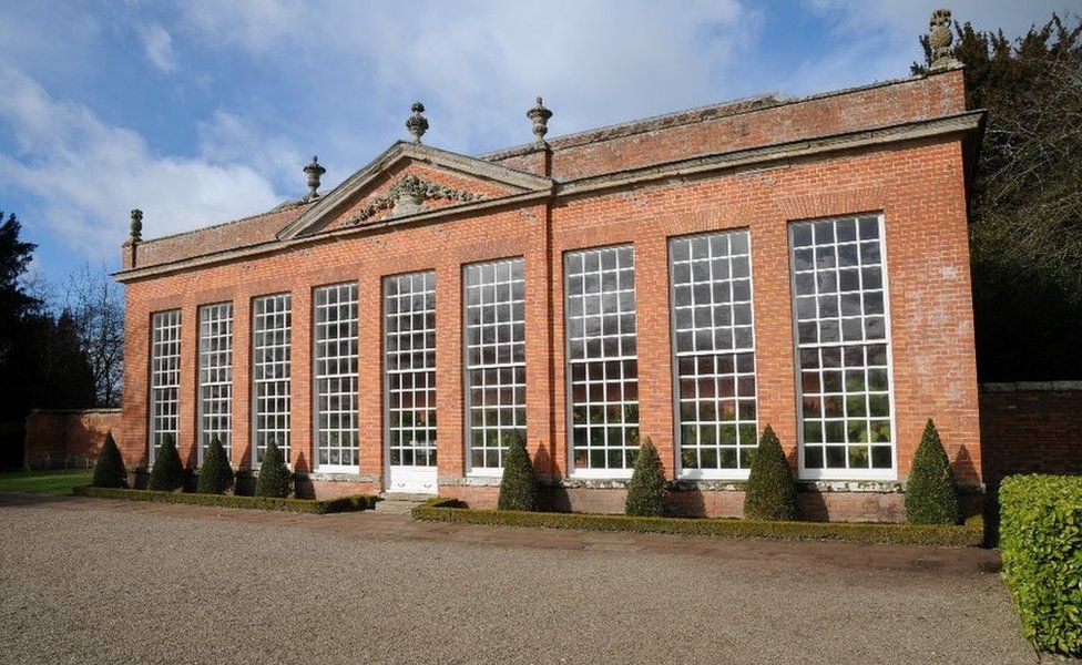 Stone pineapples are carved on an orangery at Hanbury Hall