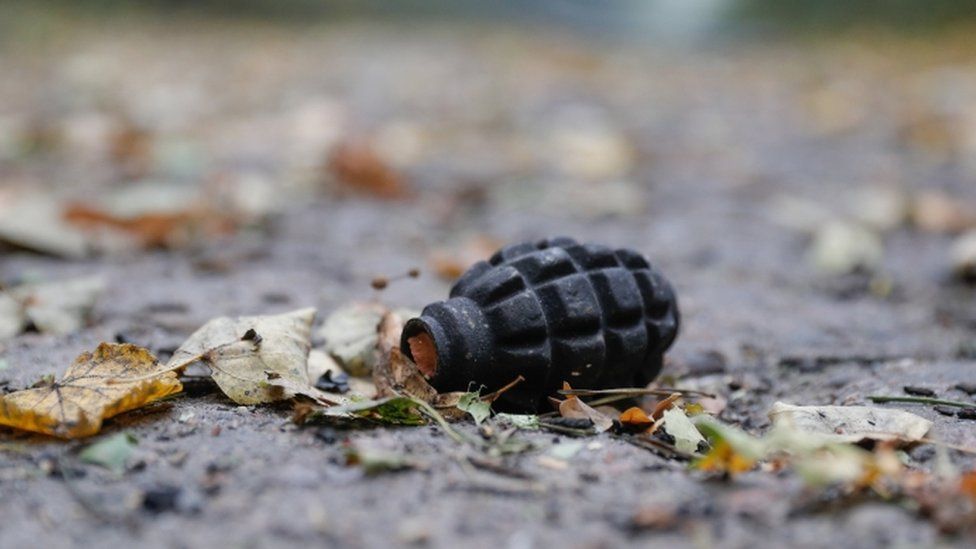 A hand grenade lies on the ground