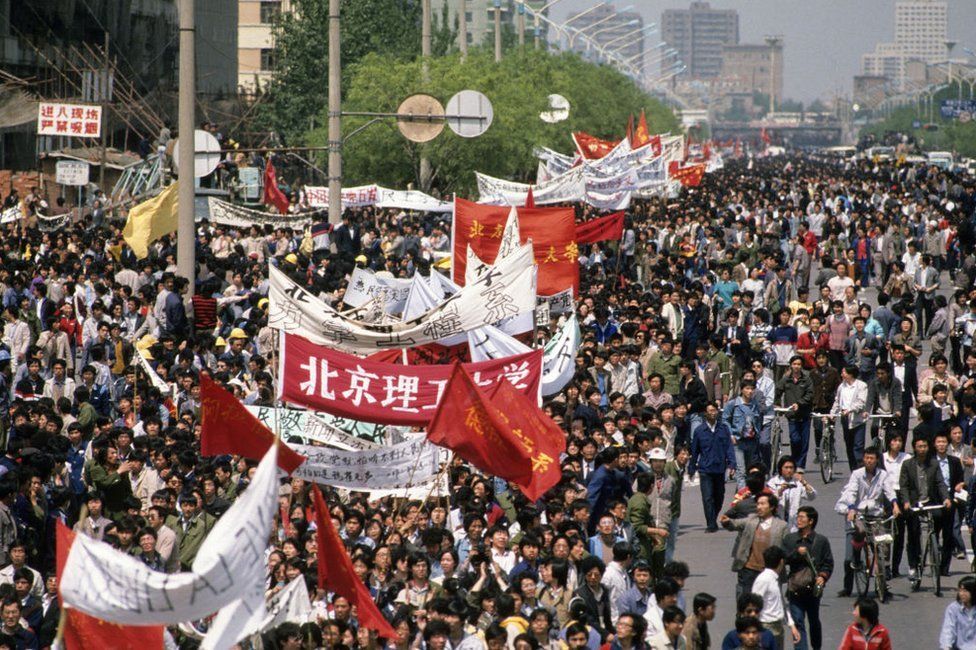 Elevated view of marchers, many with banners and flags, during a student-led, pro-democracy demonstration en route to Tiananmen Square, Beijing, China, April 27, 1989.