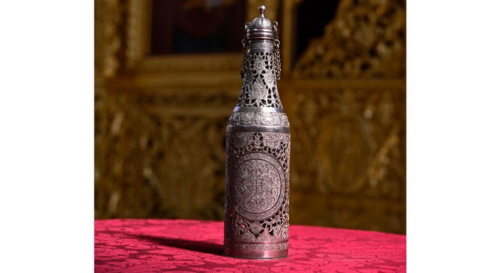 Silver urn containing chrism oil