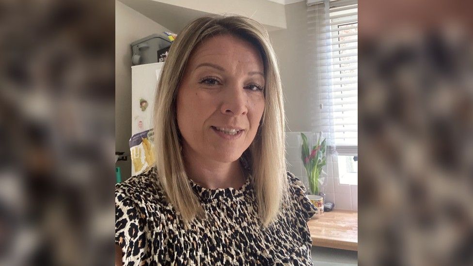 Selfie of Sophie Rollason in a kitchen - she is wearing a leopard print top