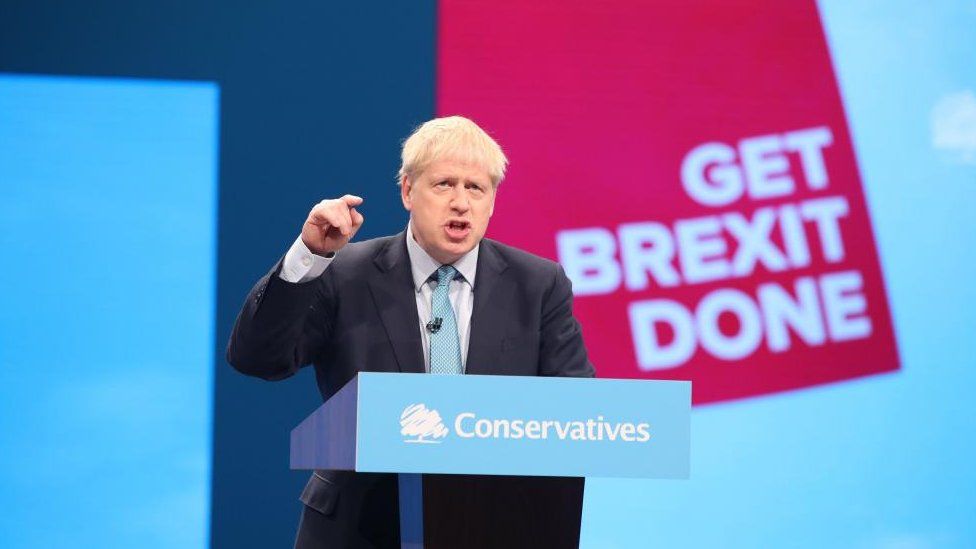Former Prime Minister Boris Johnson on stage giving his speech at the Conservative Party Conference at the Manchester Convention Centre